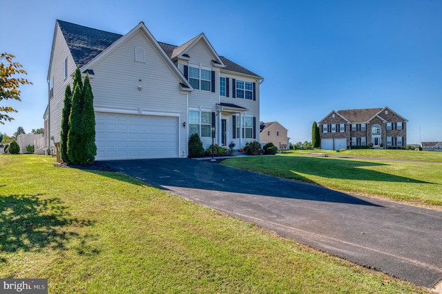 view of front of property with a garage and a front yard