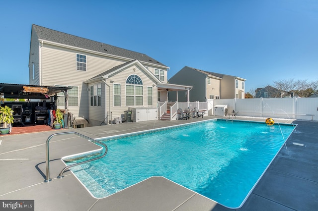 view of swimming pool featuring pool water feature and a patio