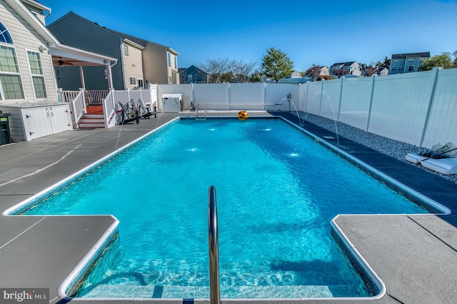 view of swimming pool with pool water feature