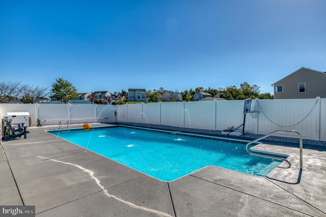 view of pool featuring pool water feature and a patio