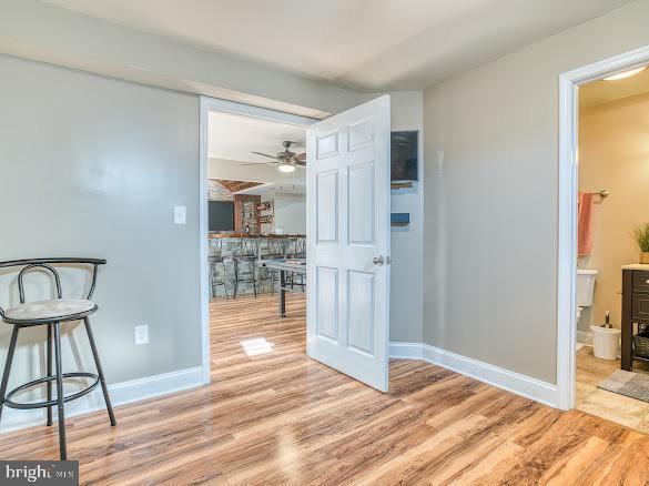 hallway with light hardwood / wood-style floors