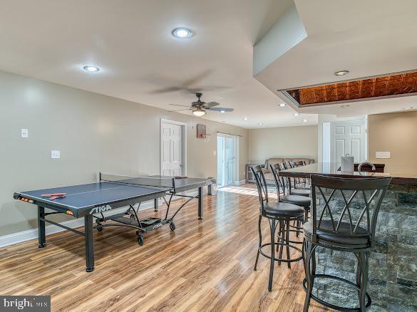 game room with ceiling fan and light hardwood / wood-style flooring