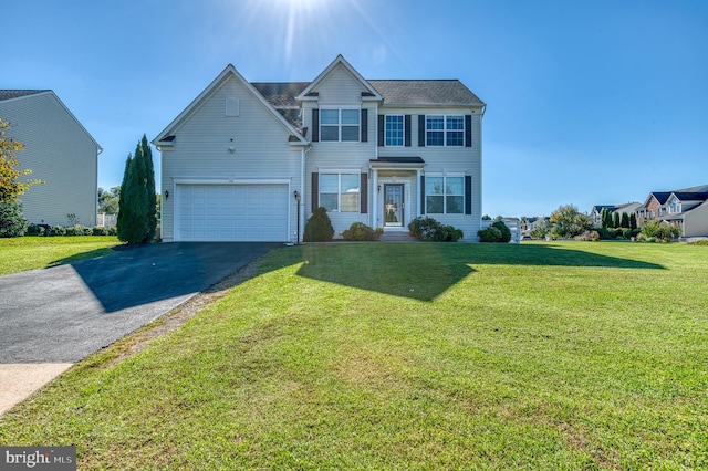 view of front facade featuring a front lawn and a garage