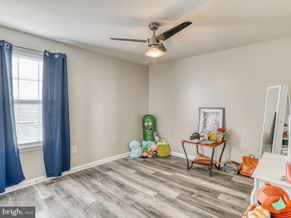 rec room featuring ceiling fan and light hardwood / wood-style floors