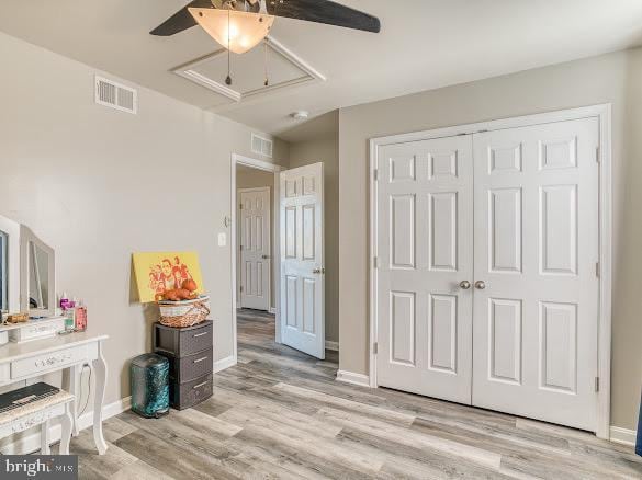 bedroom featuring ceiling fan, light wood-type flooring, and a closet