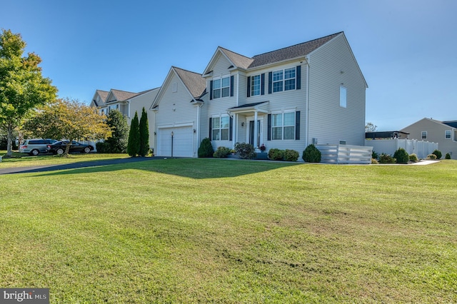 view of front of home featuring a front yard and a garage