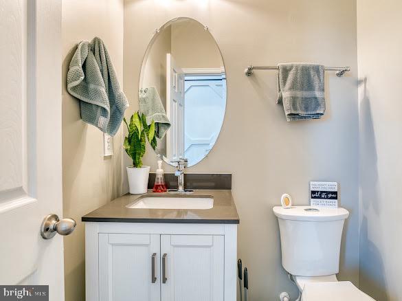 bathroom featuring vanity and toilet