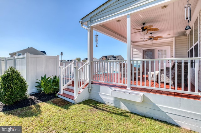 deck featuring a yard and ceiling fan