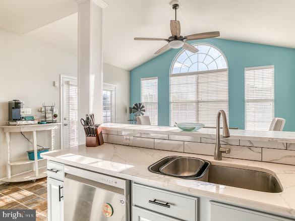 kitchen with white cabinets, dishwasher, and sink