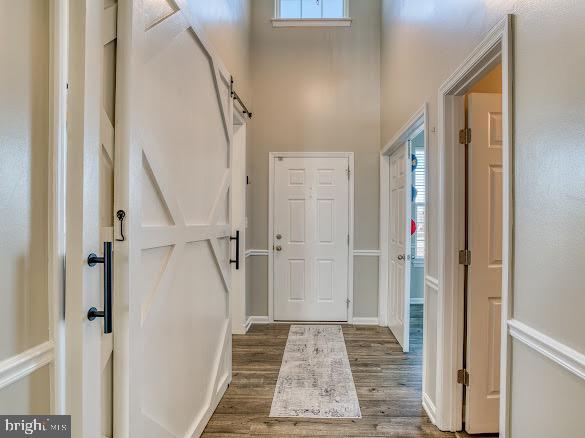 entryway with a healthy amount of sunlight and dark wood-type flooring