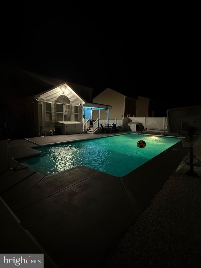 pool at night with a patio