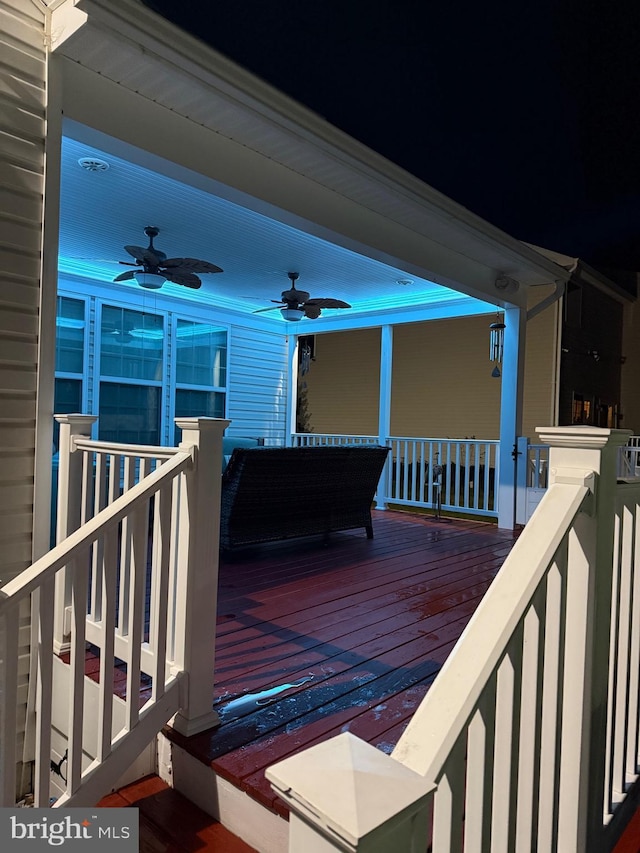 deck featuring covered porch and ceiling fan