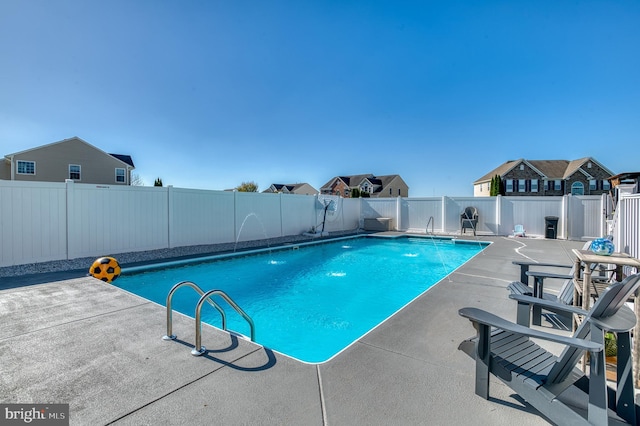 view of pool with pool water feature and a patio area