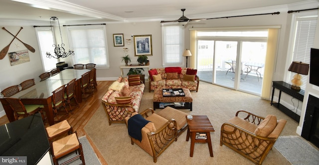 living room featuring ornamental molding, ceiling fan, and light hardwood / wood-style floors