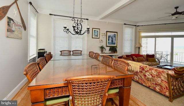 dining room featuring beam ceiling, ornamental molding, ceiling fan with notable chandelier, and light hardwood / wood-style floors