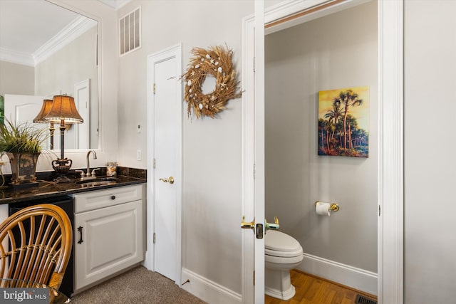 9 134th St Unit 9B, Ocean City, MD 21842 - bathroom featuring visible vents, vanity, ornamental molding, and toilet