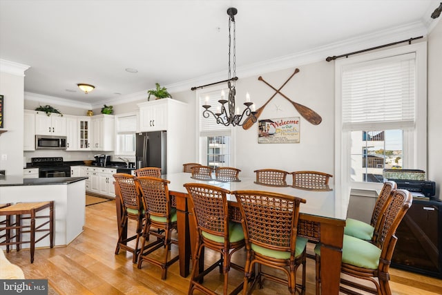 9 134th St Unit 9B, Ocean City, MD 21842 - dining space featuring a wealth of natural light, light wood-style floors, a notable chandelier, and crown molding