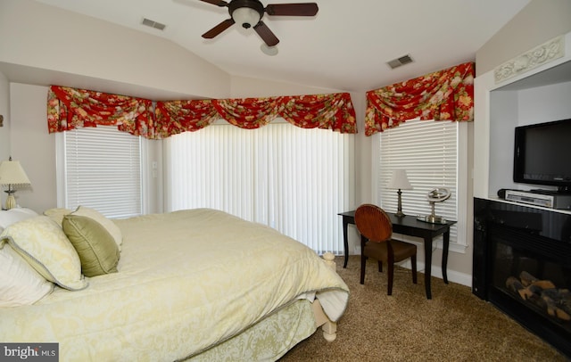 bedroom featuring carpet floors, multiple windows, vaulted ceiling, and ceiling fan