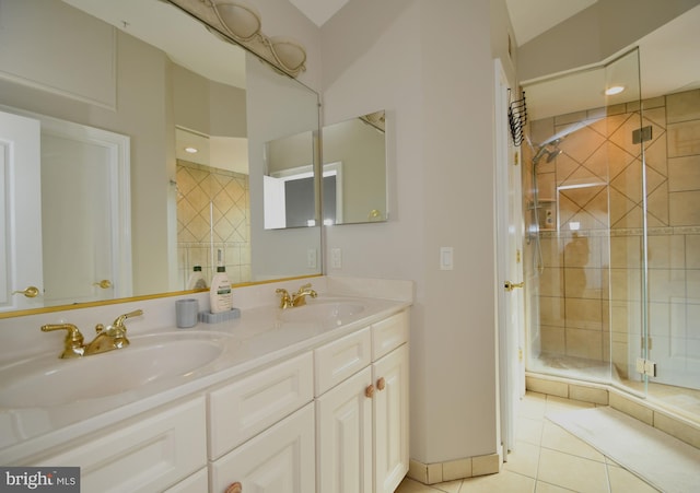 bathroom featuring tile patterned flooring, an enclosed shower, and vanity