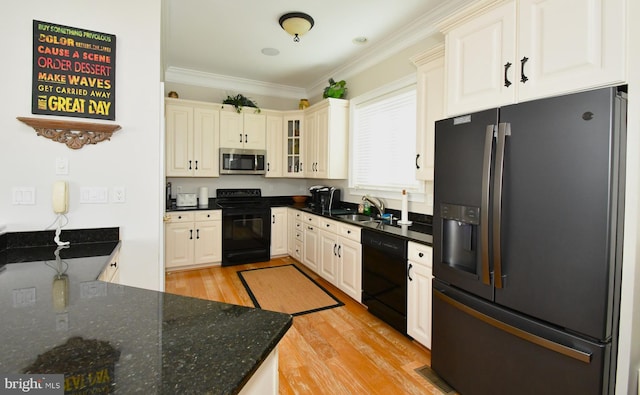 9 134th St Unit 9B, Ocean City, MD 21842 - kitchen with light wood-style flooring, a sink, glass insert cabinets, crown molding, and black appliances