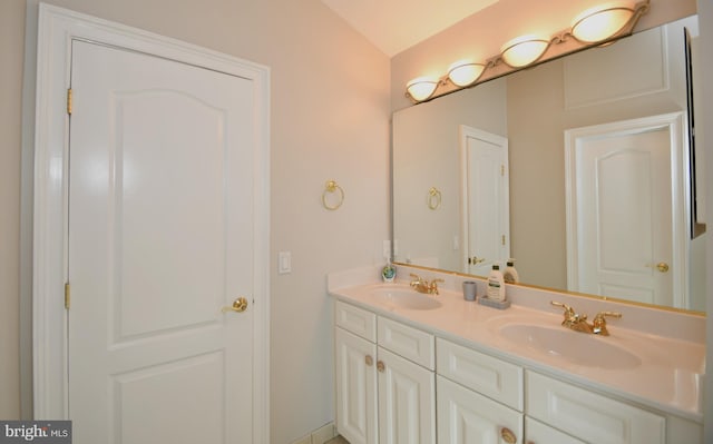 bathroom featuring vanity and vaulted ceiling