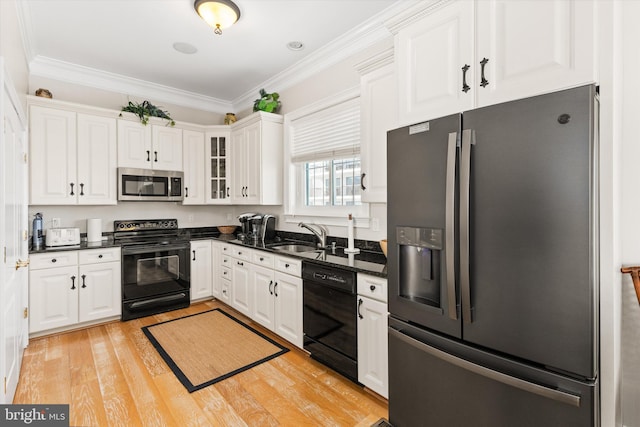 9 134th St Unit 9B, Ocean City, MD 21842 - kitchen featuring white cabinets, ornamental molding, and black appliances