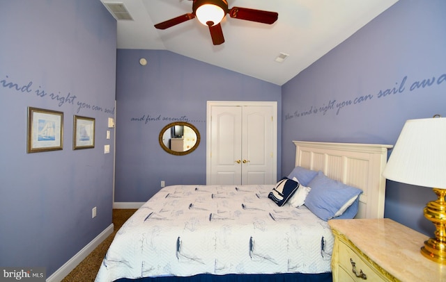 bedroom with ceiling fan, lofted ceiling, dark carpet, and a closet