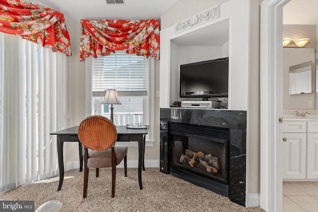 9 134th St Unit 9B, Ocean City, MD 21842 - office featuring a glass covered fireplace, visible vents, light colored carpet, and a sink