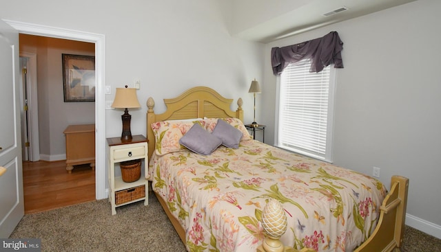 bedroom with carpet floors and multiple windows