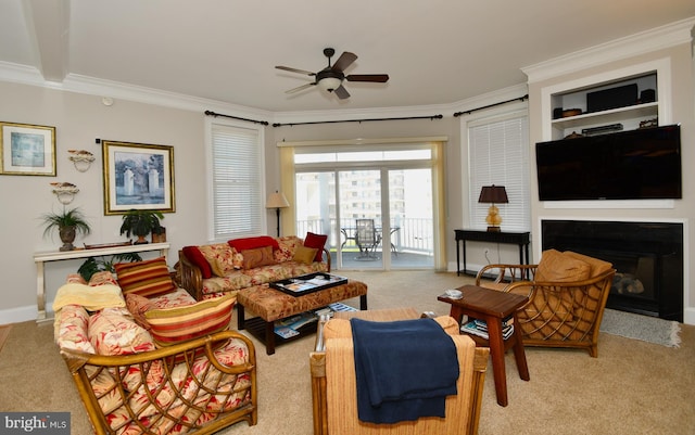 carpeted living room featuring ceiling fan and ornamental molding