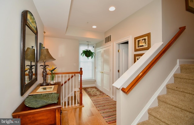 stairway with hardwood / wood-style floors