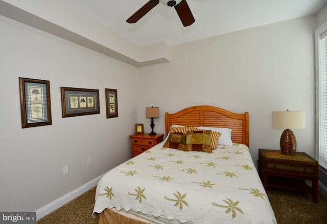 bedroom featuring ceiling fan and dark carpet