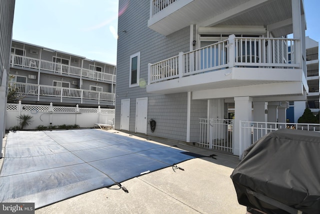 view of pool with area for grilling and a patio area