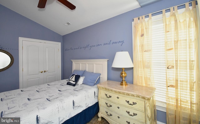 bedroom featuring lofted ceiling, a closet, and ceiling fan