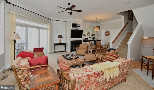 living room featuring crown molding and ceiling fan