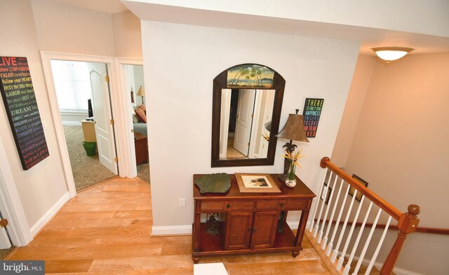 9 134th St Unit 9B, Ocean City, MD 21842 - hall featuring light wood-style floors, stairway, and baseboards
