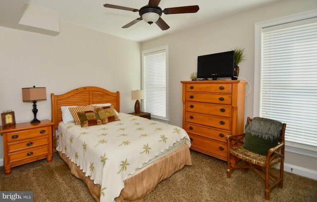 carpeted bedroom with multiple windows and ceiling fan