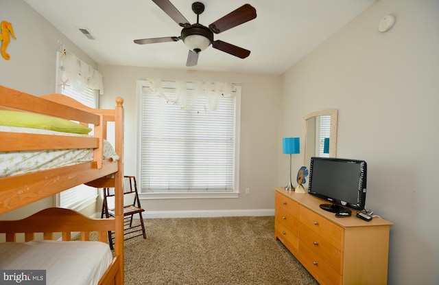 bedroom featuring ceiling fan and dark carpet