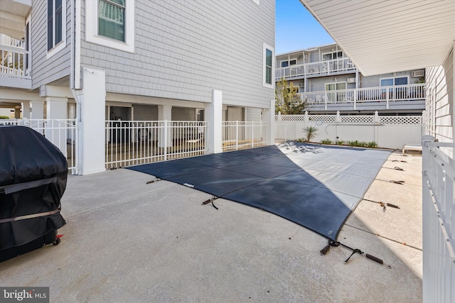 view of pool featuring area for grilling and a patio