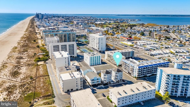 birds eye view of property with a beach view and a water view