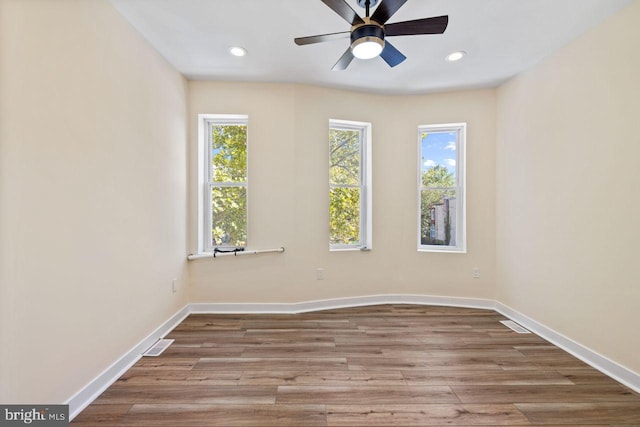 empty room with light wood-type flooring and ceiling fan