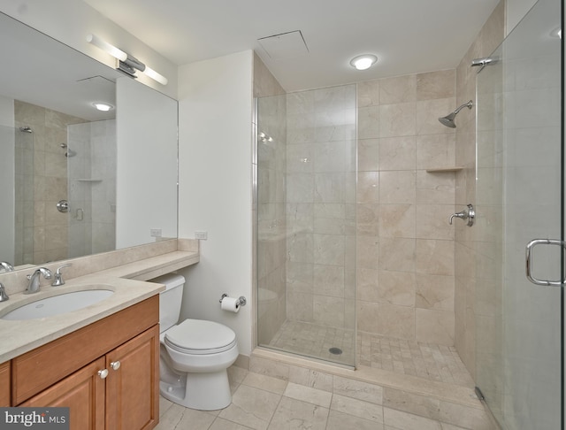 bathroom featuring toilet, walk in shower, vanity, and tile patterned floors