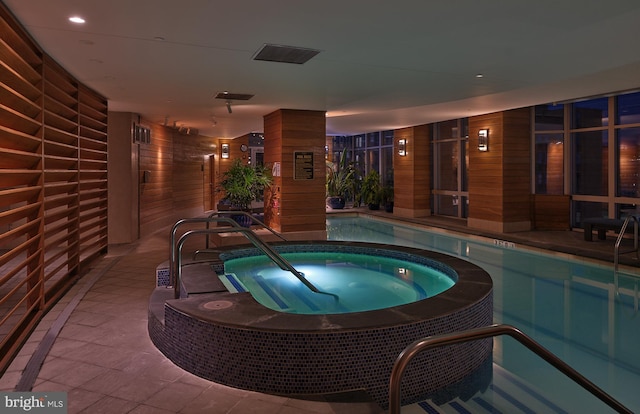 view of swimming pool with a patio area and an indoor in ground hot tub