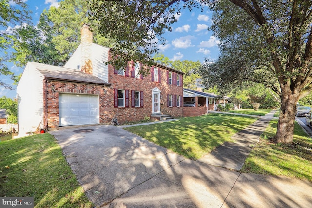 colonial home with a garage and a front lawn