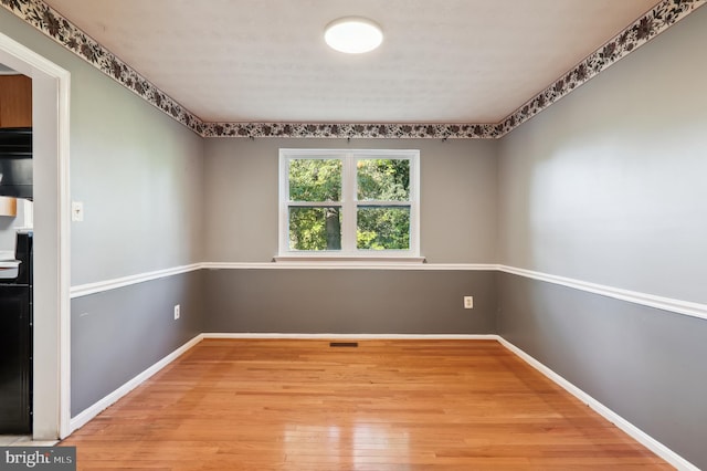 unfurnished room with light wood-type flooring