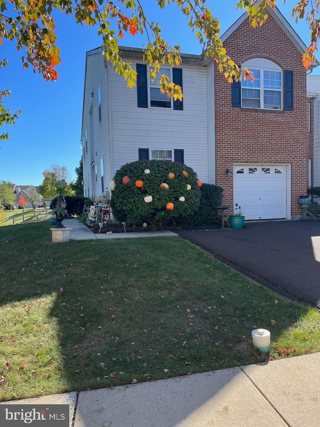 view of front facade featuring a garage and a front lawn