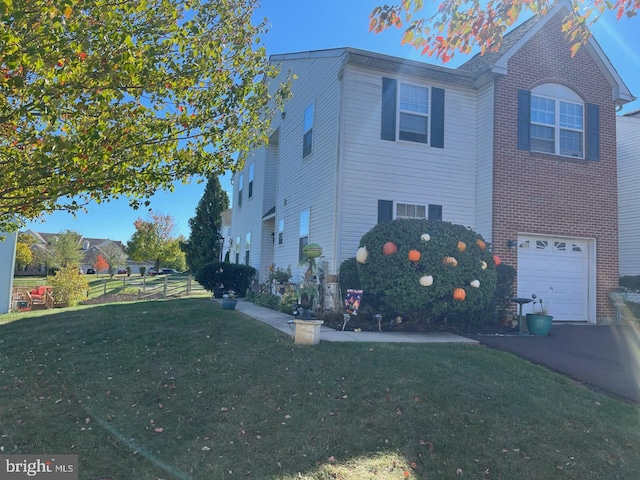 view of front of home with a front yard and a garage