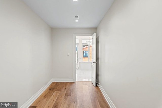 interior space with light wood-style floors, visible vents, and baseboards