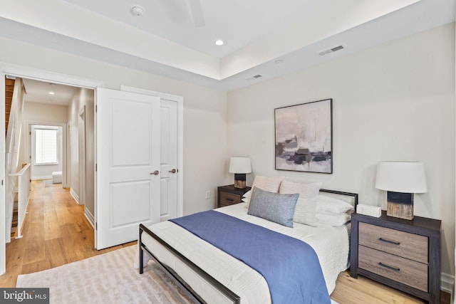 bedroom with recessed lighting, a closet, visible vents, light wood-style floors, and baseboards