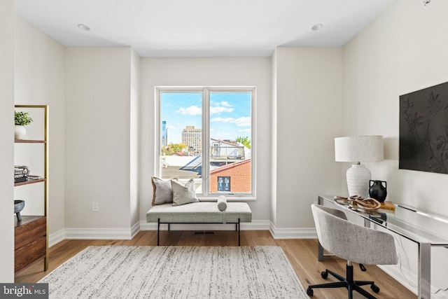 office space featuring light wood-style flooring and baseboards